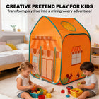 Two toddlers sitting on a rug in a bedroom, playing with plastic toy food and baskets in front of the grocery play tent