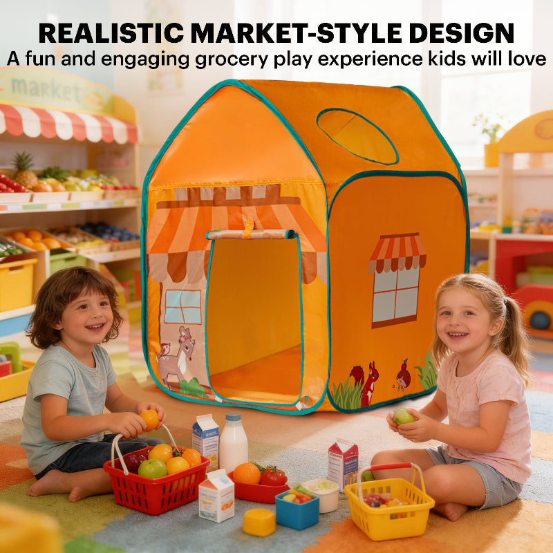 Two smiling children sitting on a colorful playroom floor surrounded by toy groceries, milk cartons, and baskets in front of a market-style play tent.